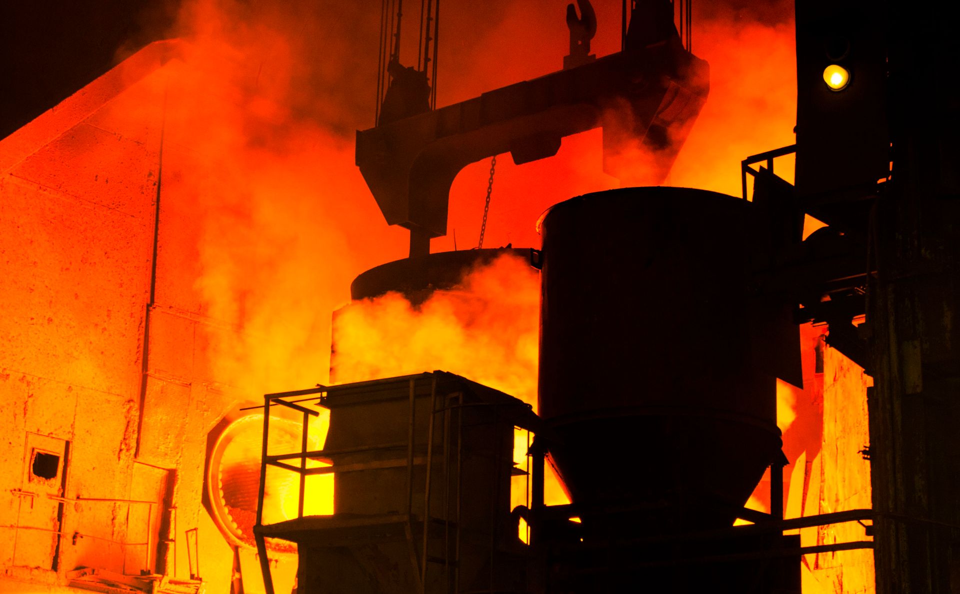 Steel plant casting area glowing with molten metal