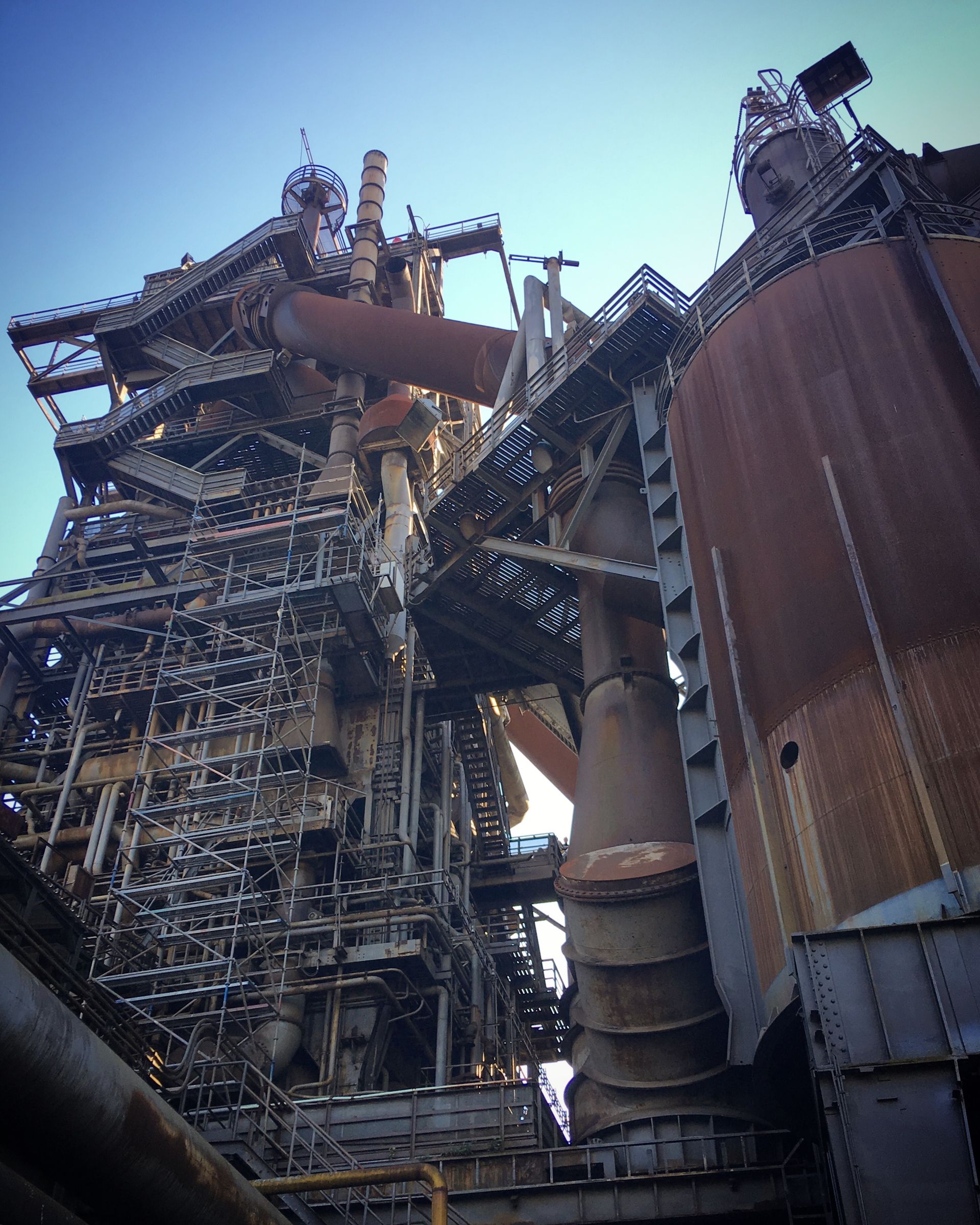 Steel plant structure against a blue sky