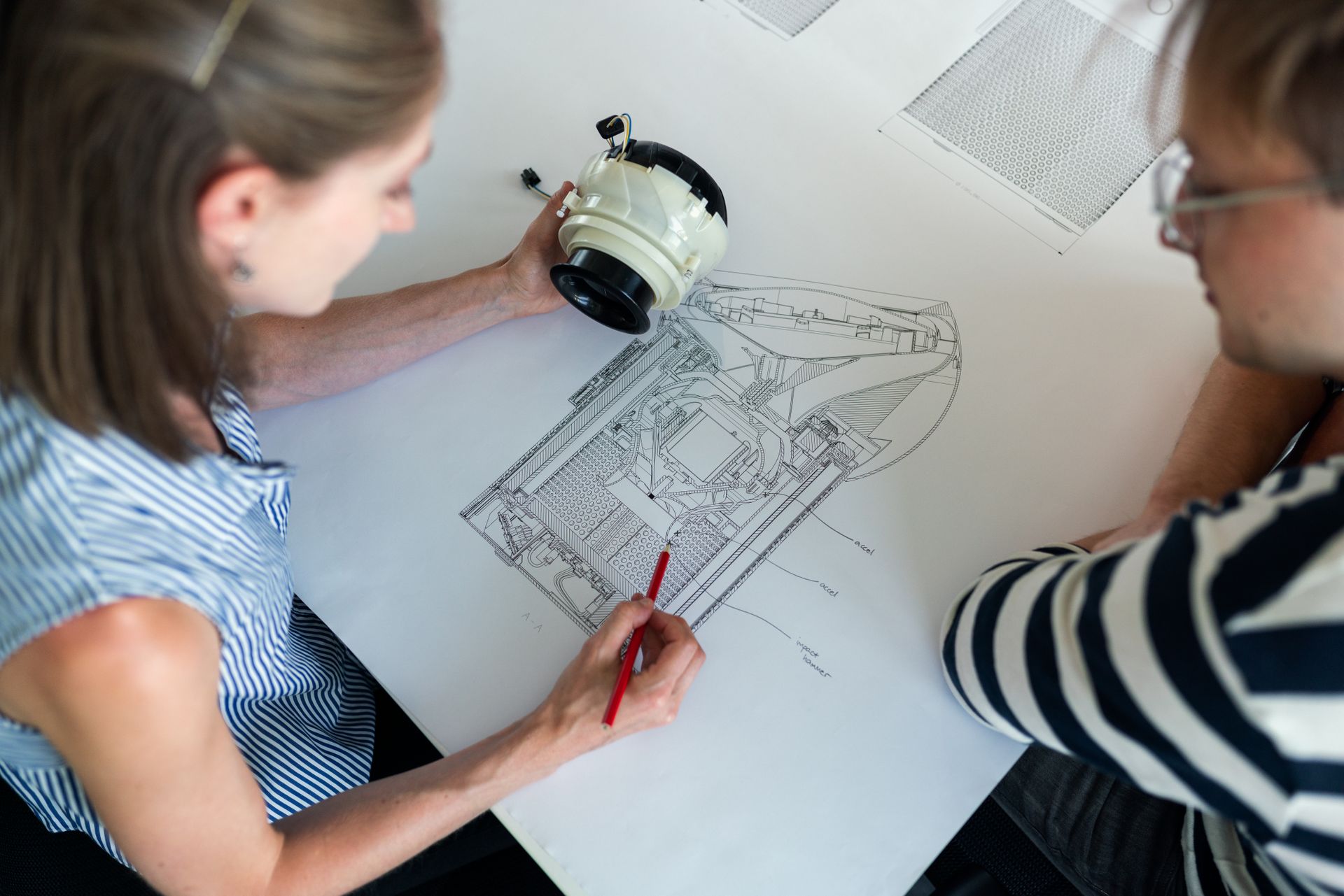 Advisors reviewing a technical drawing